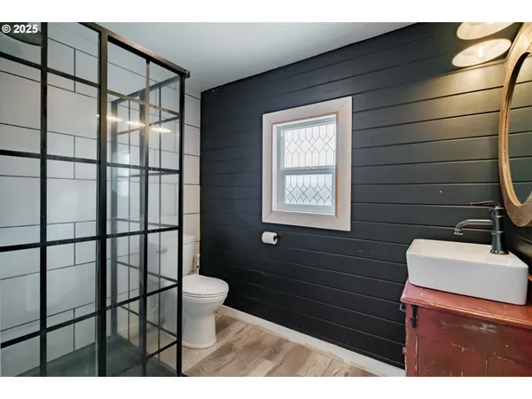 a living room with furniture a flat screen tv and gym equipment