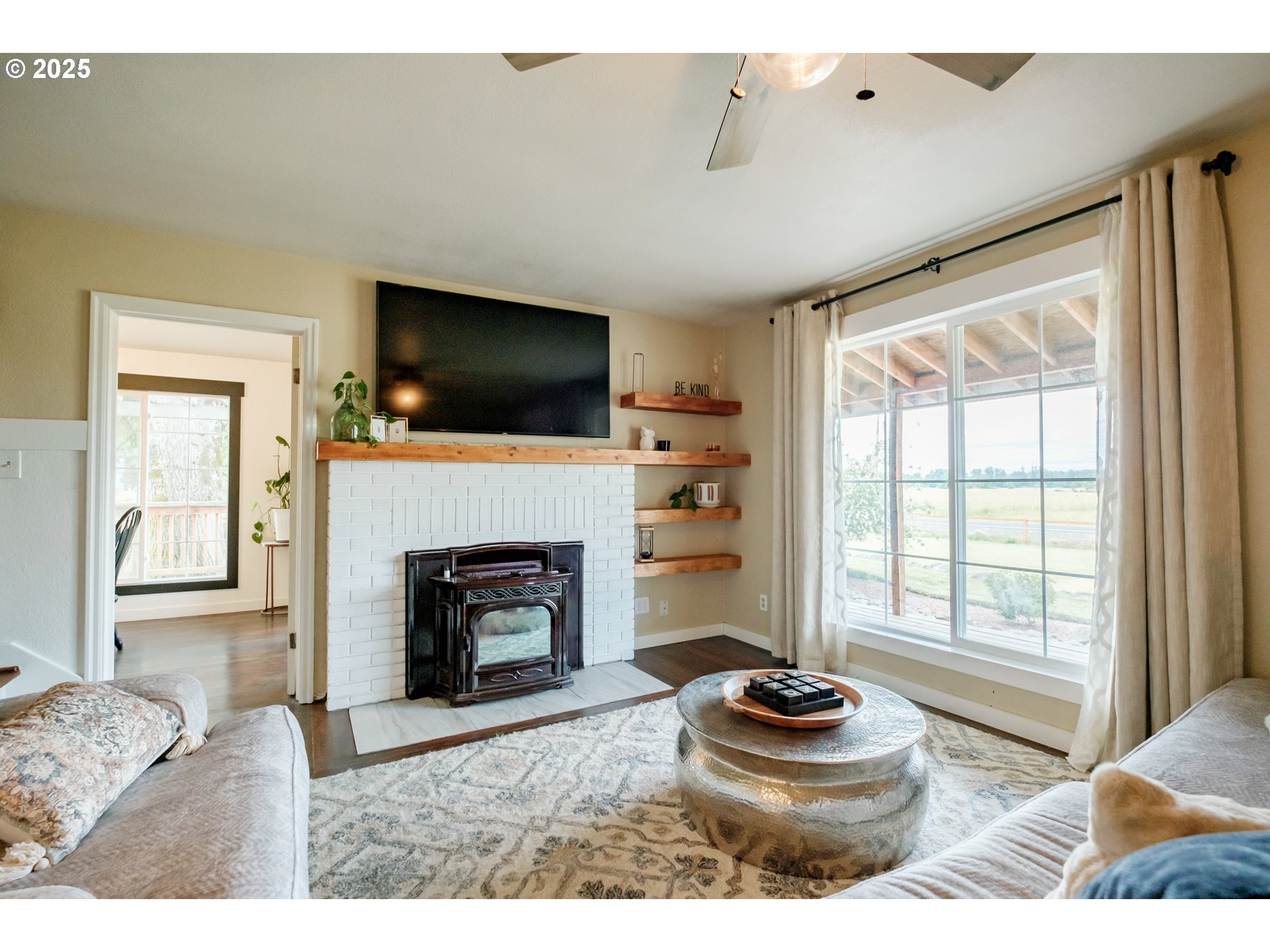 37929 Kelly Road Scio, OR 97374 - Photo 5 of 48 a living room with a fireplace and a flat screen tv