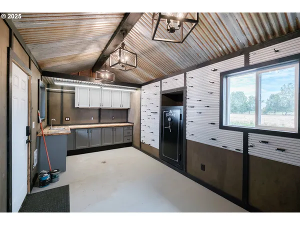 a kitchen with stainless steel appliances kitchen island granite countertop a refrigerator and window