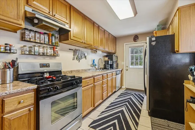 a kitchen with stainless steel appliances granite countertop a stove and a refrigerator