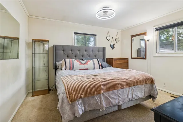 a bedroom with a bed and window