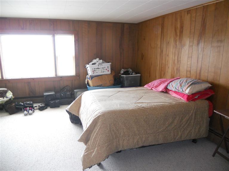 40 Bayview Road Mashpee, MA 02649 - Photo 18 of 23 a bedroom with a bed and wooden floor
