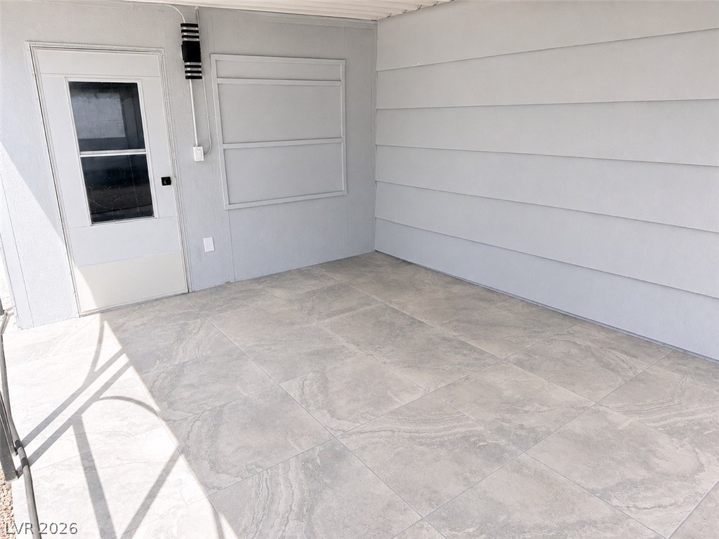 324 Lakehurst Road Las Vegas, NV 89145 - Photo 22 of 30 Tiled flooring and clean siding define this versatile covered outdoor area.