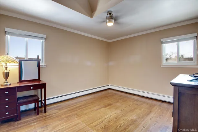 wooden floor in an empty room with a window