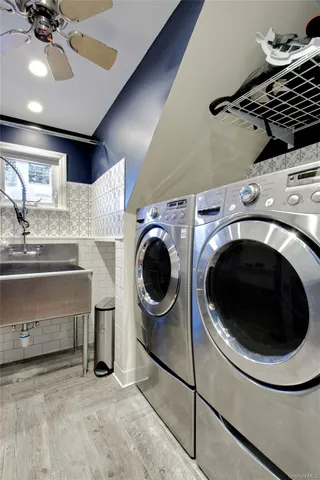 a utility room with sink dryer and washer