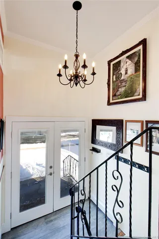 a view of a hallway with wooden floor and staircase
