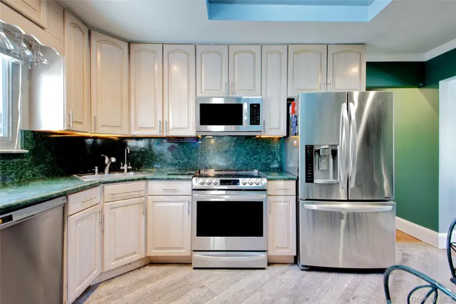 a kitchen with a refrigerator stove and microwave