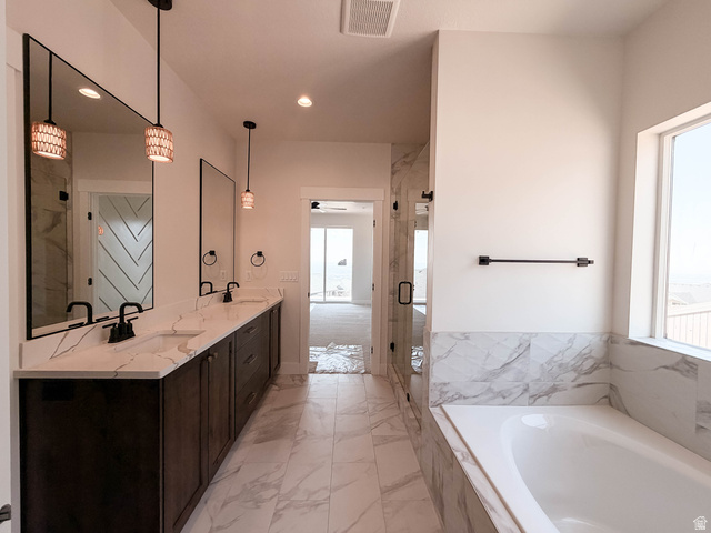 619 East Mountain Road North Ogden, UT 84414 - Photo 6 of 8 Spacious bathroom featuring a double vanity with stone countertops, undermount sinks, and dark cabinetry