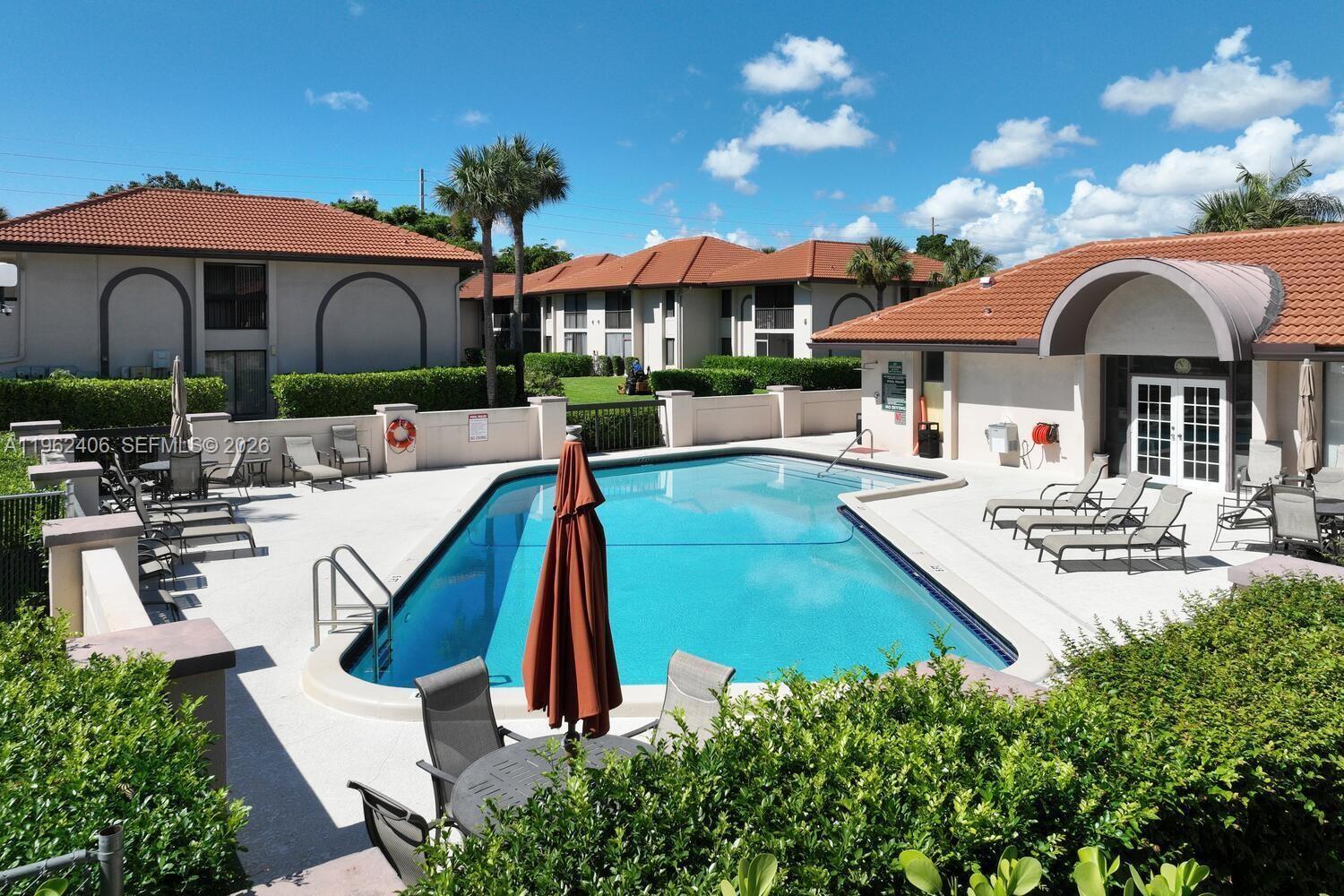 351 Club Circle, Unit 102 Boca Raton, FL 33487 - Photo 32 of 34 a view of a house with swimming pool and sitting area