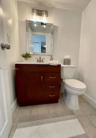 a spacious bathroom with a double vanity sink toilet mirror and shower