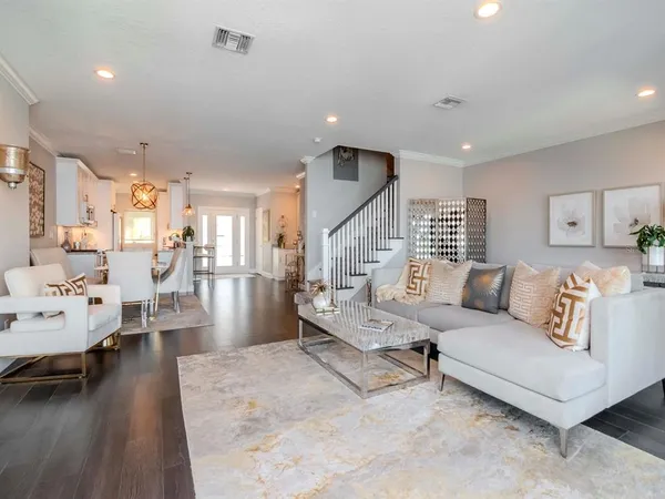 a spacious bedroom with a bed and a chandelier