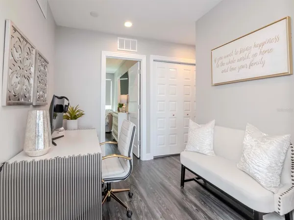 a bedroom with a large bed and a flat screen tv