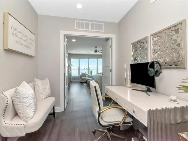 a bedroom with a bed and a large window