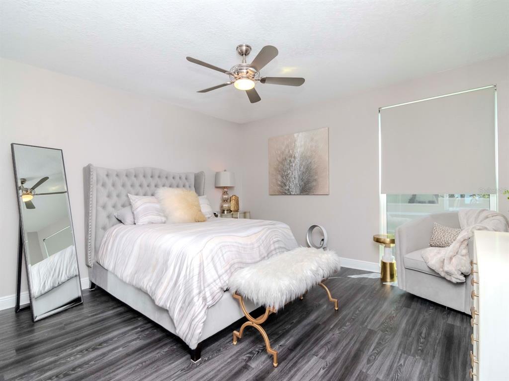 2807 West Hawthorne Road, Unit 11 Tampa, FL 33611 - Photo 25 of 76 a bedroom with a bed and wooden floor
