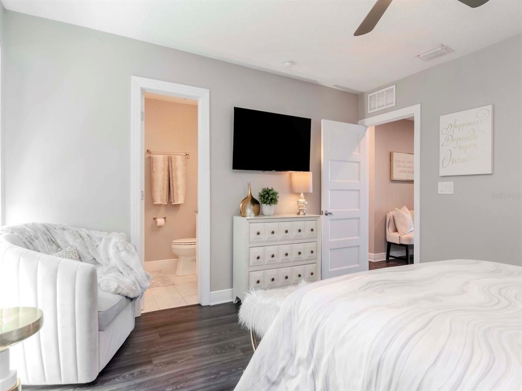 2807 West Hawthorne Road, Unit 11 Tampa, FL 33611 - Photo 26 of 76 a bedroom with a bed and a flat screen tv