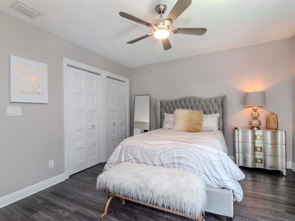 2807 West Hawthorne Road, Unit 11 Tampa, FL 33611 - Photo 27 of 76 a bedroom with a bed and a chandelier