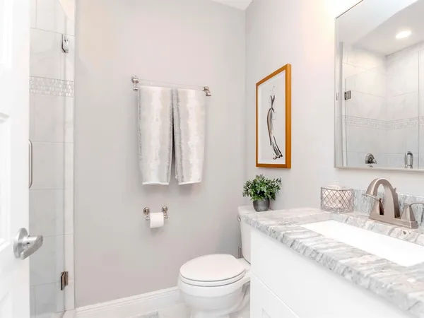 a bathroom with a tub a sink and mirror
