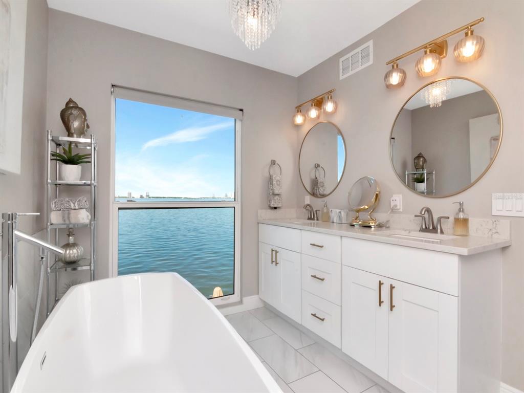 2807 West Hawthorne Road, Unit 11 Tampa, FL 33611 - Photo 38 of 76 a spacious bathroom with a double vanity sink and a mirror