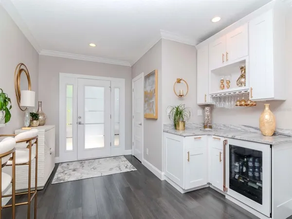 a large white kitchen with granite countertop a sink white cabinets and a granite counter tops