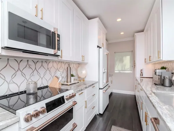 a living room with furniture large window and wooden floor