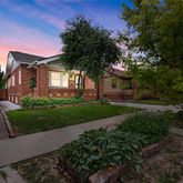 a front view of a house with a yard and potted plants