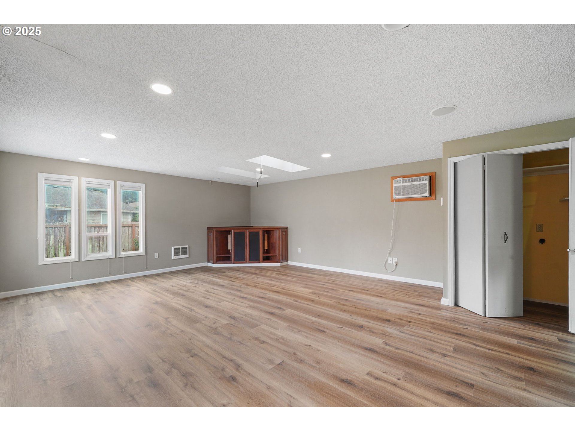 550 Evergreen Loop Reedsport, OR 97467 - Photo 11 of 35 a view of an empty room with wooden floor and windows