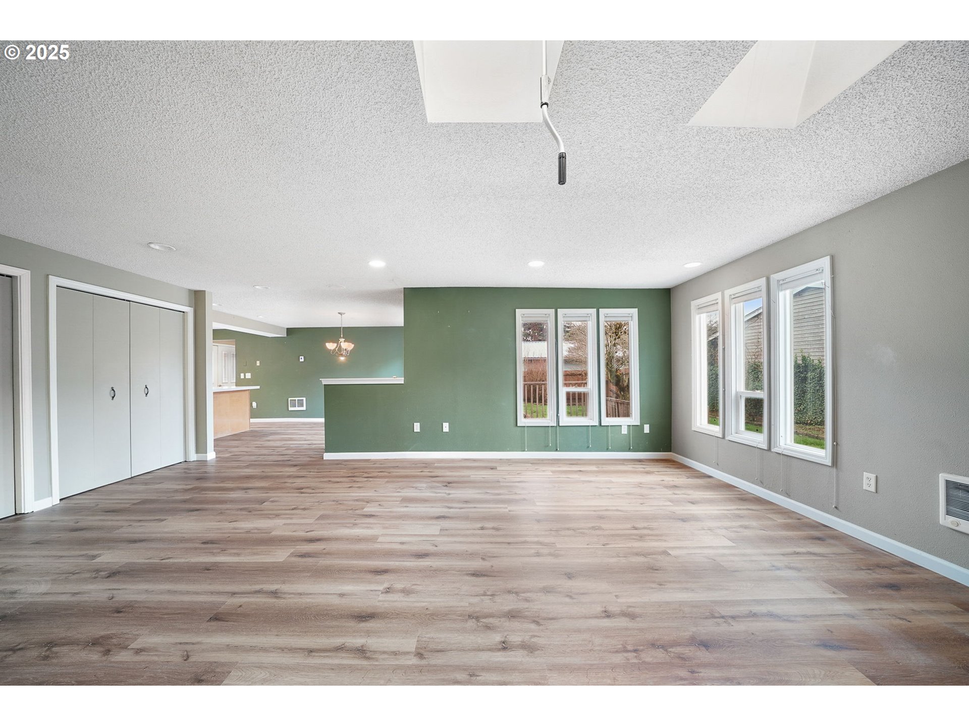 550 Evergreen Loop Reedsport, OR 97467 - Photo 14 of 35 a view of an empty room with wooden floor and a window