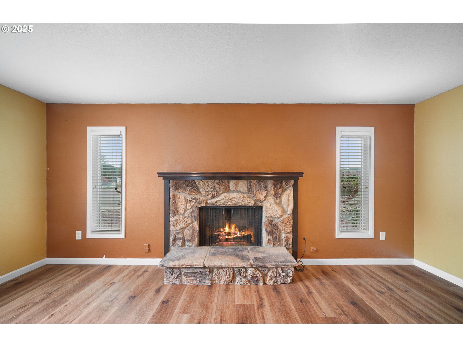 550 Evergreen Loop Reedsport, OR 97467 - Photo 20 of 35 a view of an empty room with wooden floor fireplace and a window