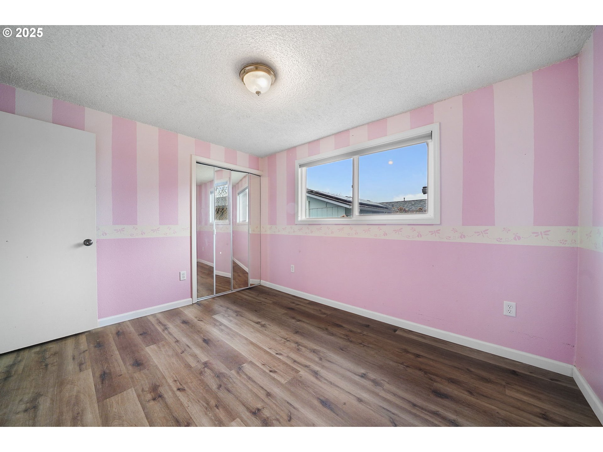550 Evergreen Loop Reedsport, OR 97467 - Photo 25 of 35 a view of an empty room with wooden floor