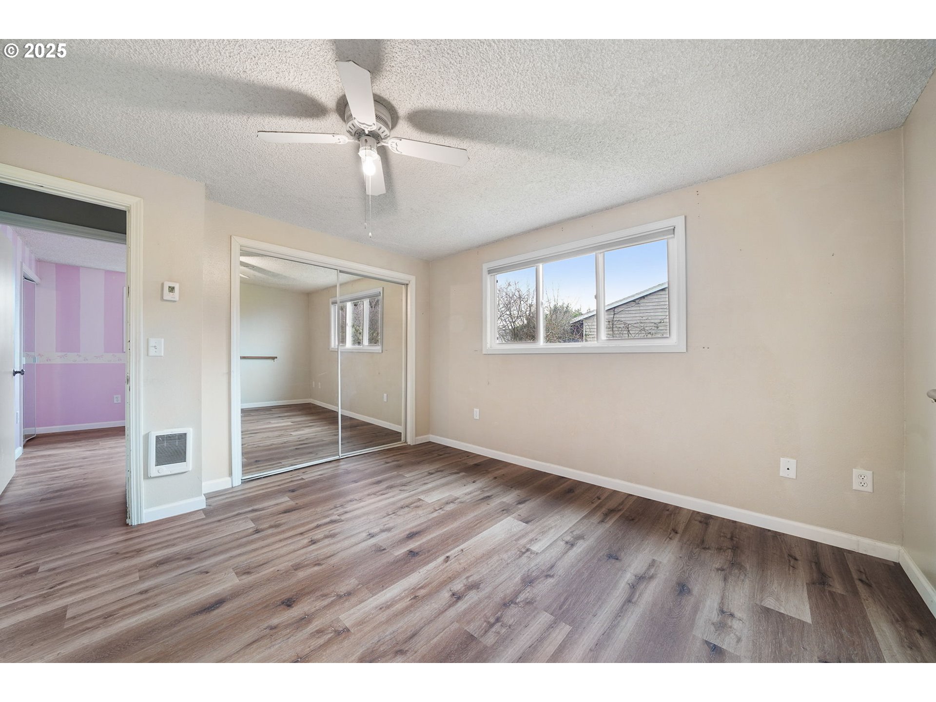 550 Evergreen Loop Reedsport, OR 97467 - Photo 27 of 35 wooden floor in an empty room with a window