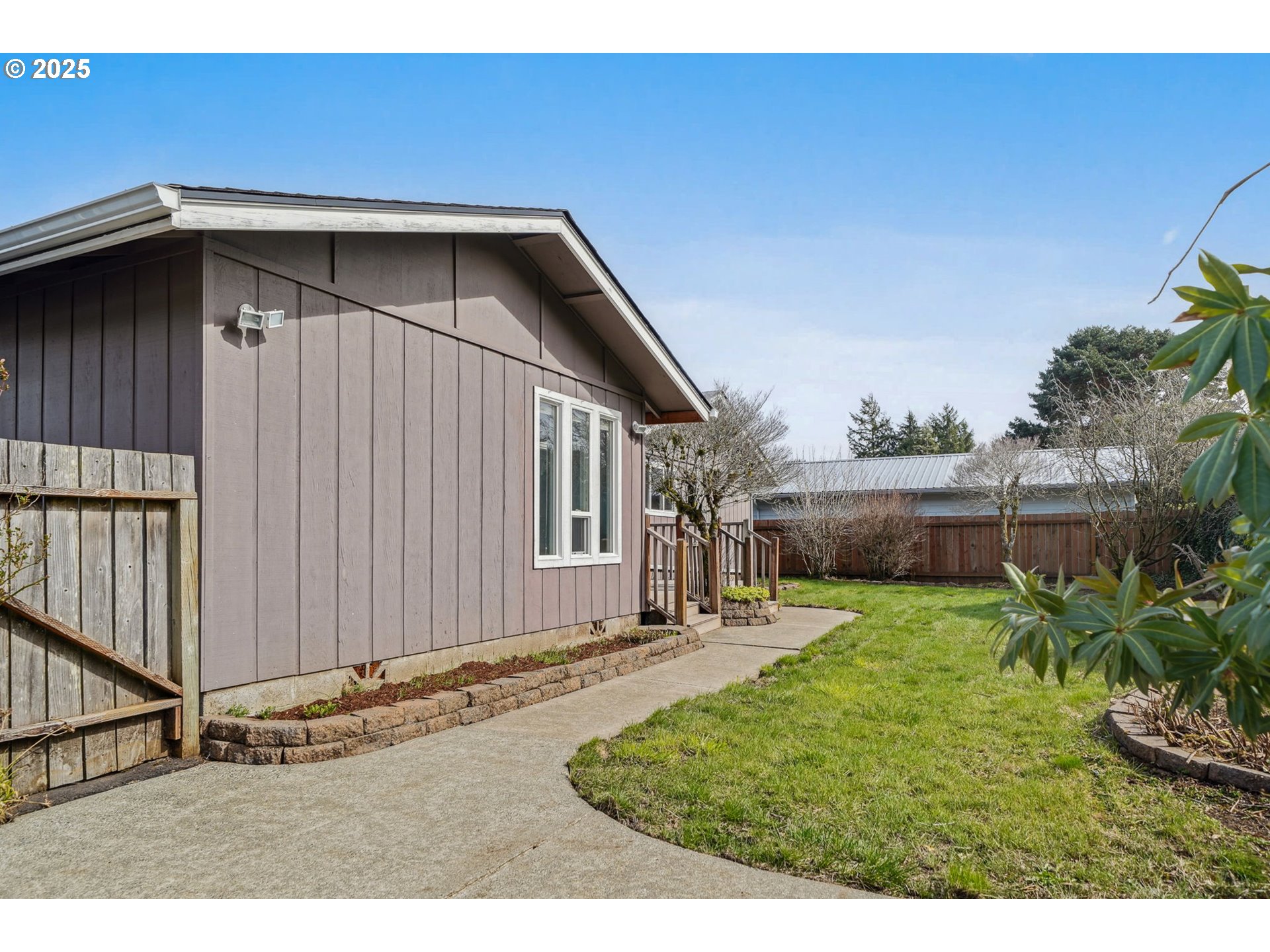 550 Evergreen Loop Reedsport, OR 97467 - Photo 32 of 35 a backyard of a house with table and chairs
