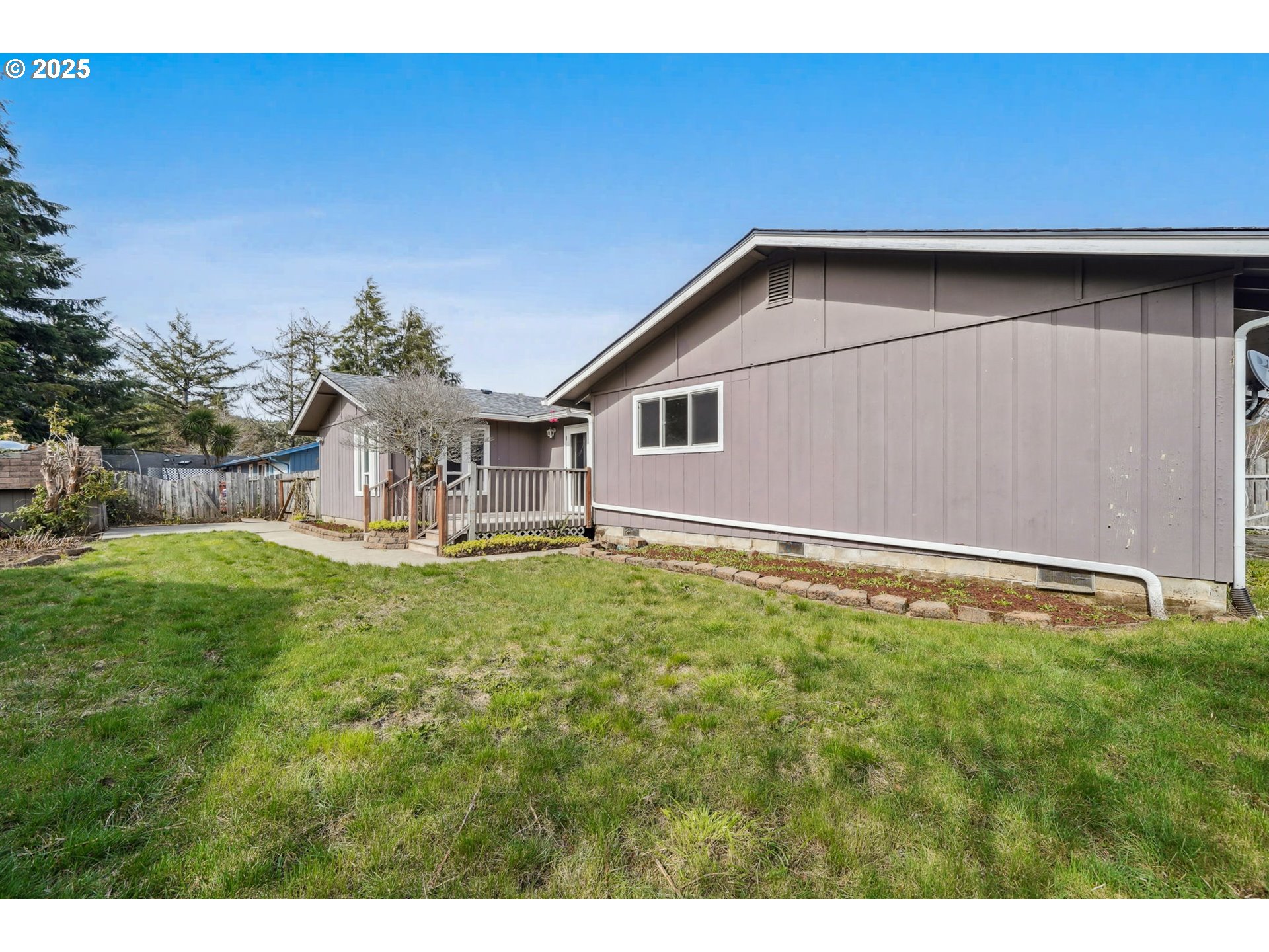550 Evergreen Loop Reedsport, OR 97467 - Photo 33 of 35 a backyard of a house with table and chairs