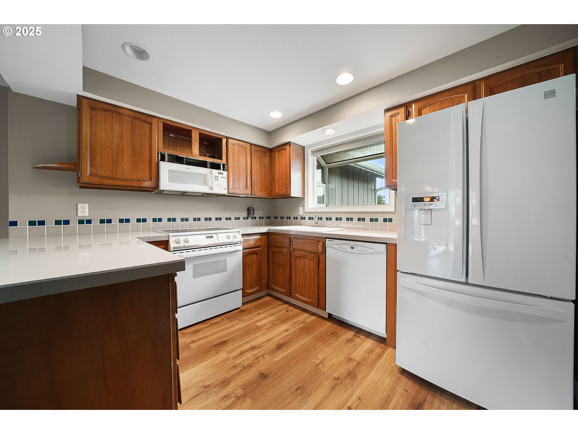 550 Evergreen Loop Reedsport, OR 97467 - Photo 6 of 35 a kitchen with stainless steel appliances a refrigerator sink and cabinets