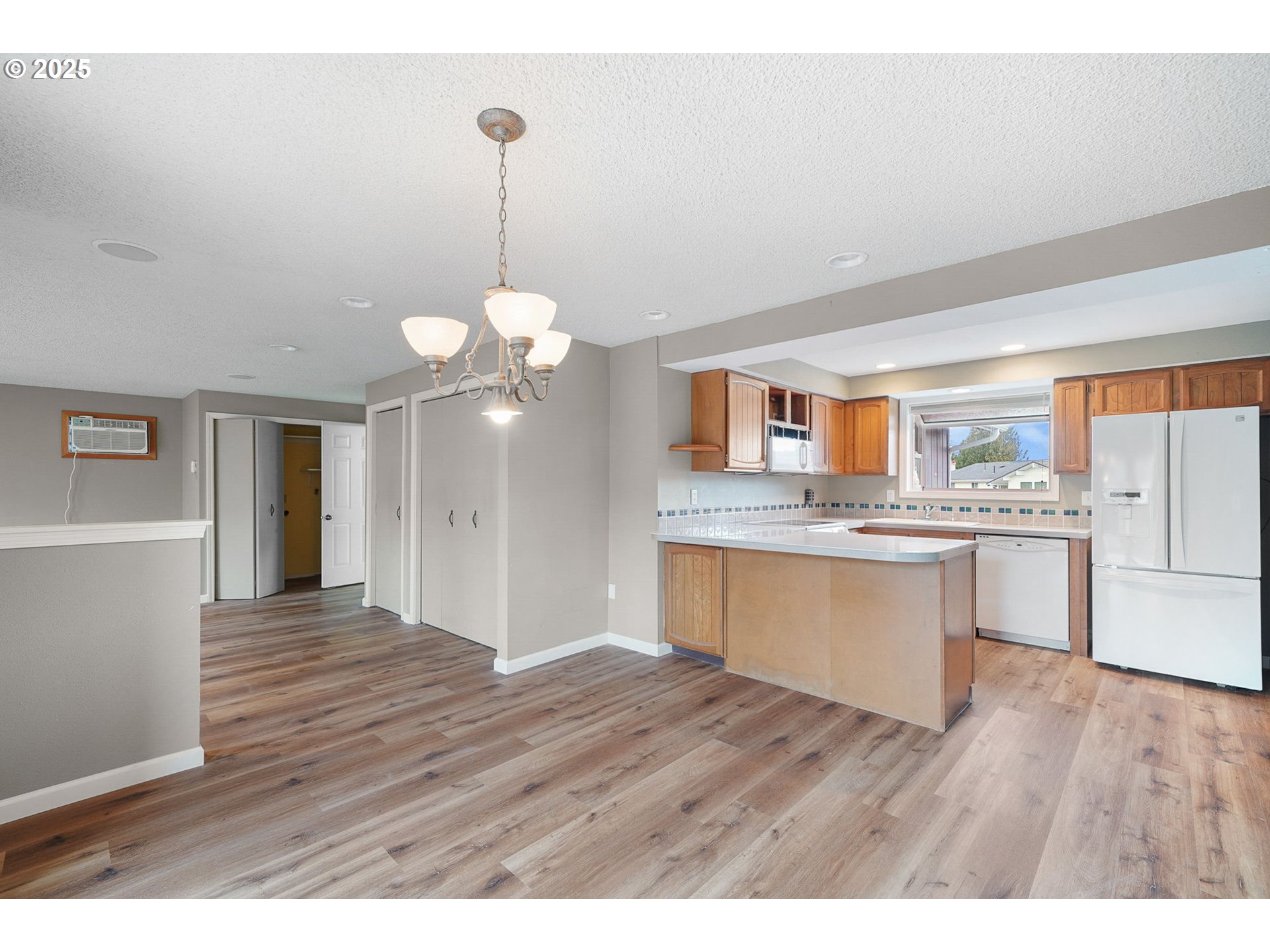 550 Evergreen Loop Reedsport, OR 97467 - Photo 8 of 35 a open kitchen with a sink dishwasher a stove and white countertops with wooden floor
