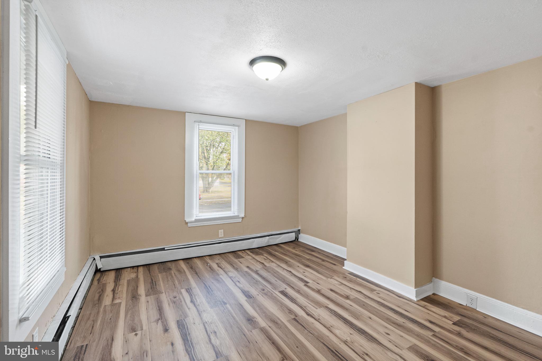 50 Pine Street Beverly, NJ 08010 - Photo 12 of 18 a view of an empty room with wooden floor and a window