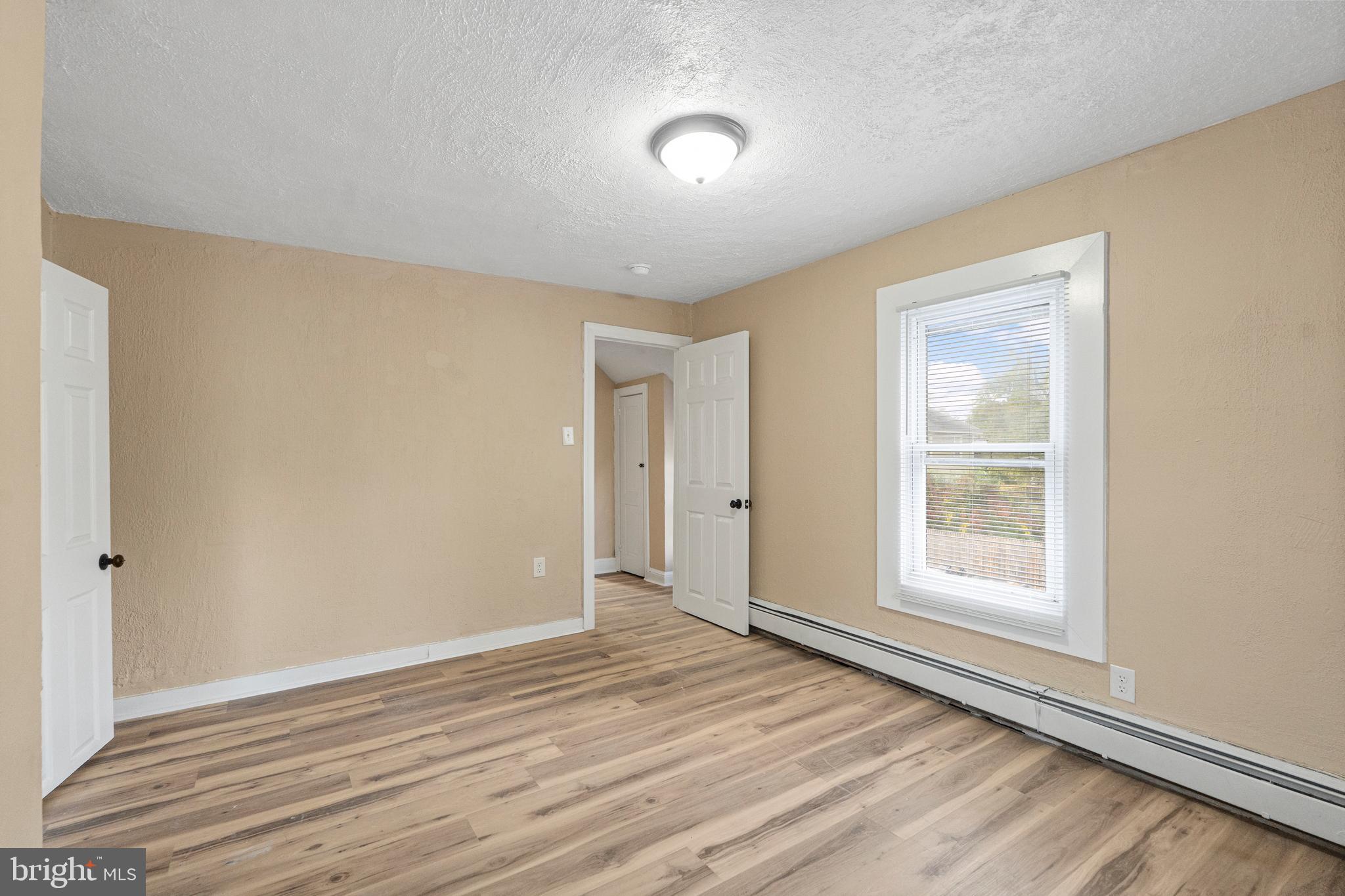50 Pine Street Beverly, NJ 08010 - Photo 15 of 18 a view of an empty room with wooden floor and a window
