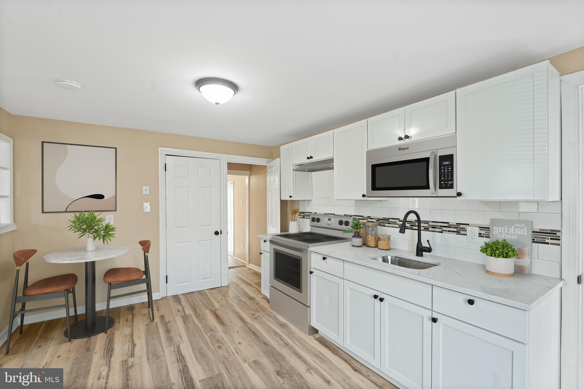50 Pine Street Beverly, NJ 08010 - Photo 4 of 18 a kitchen with a sink microwave and cabinets