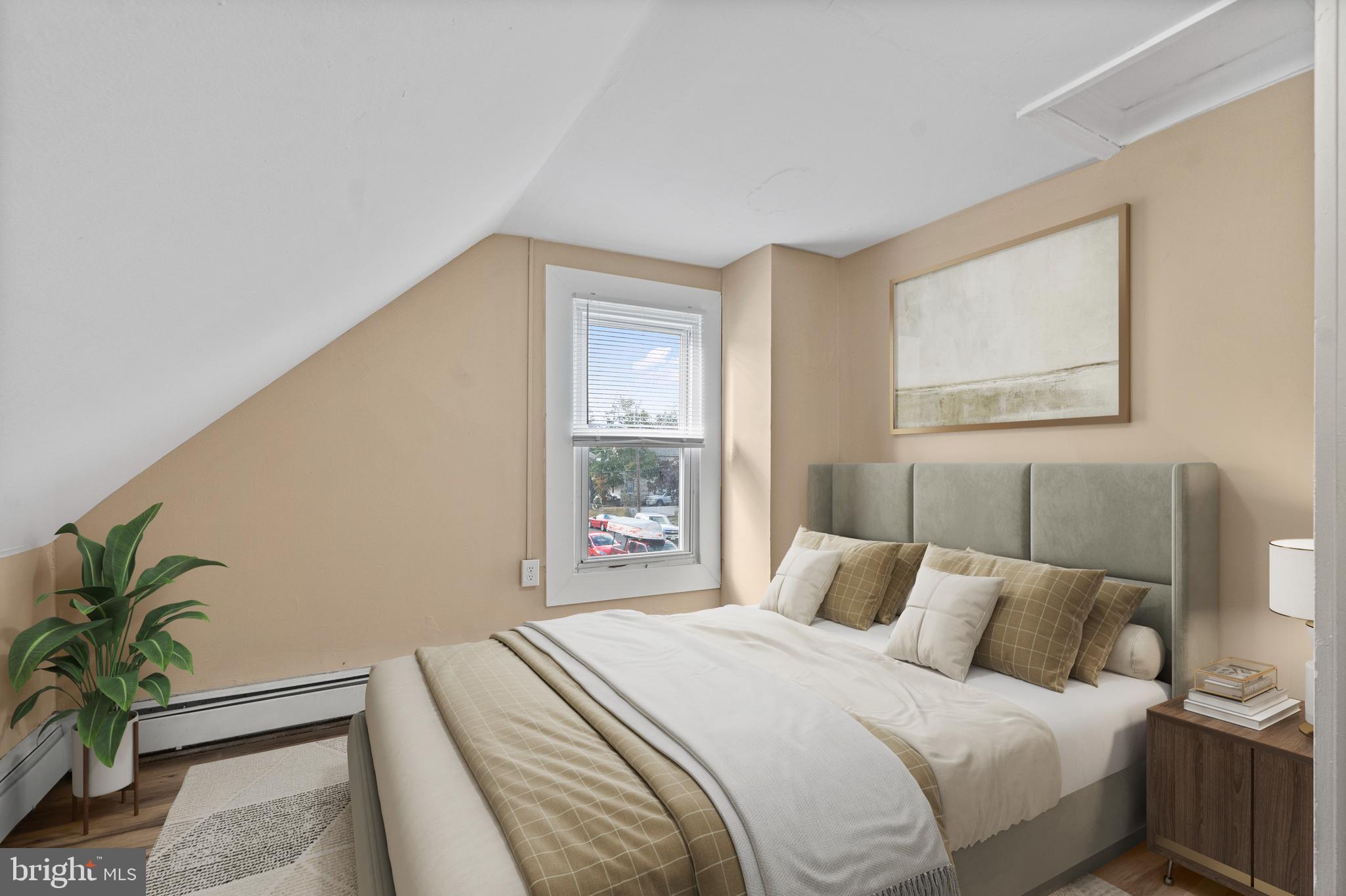 50 Pine Street Beverly, NJ 08010 - Photo 6 of 18 a bedroom with a bed and a potted plant