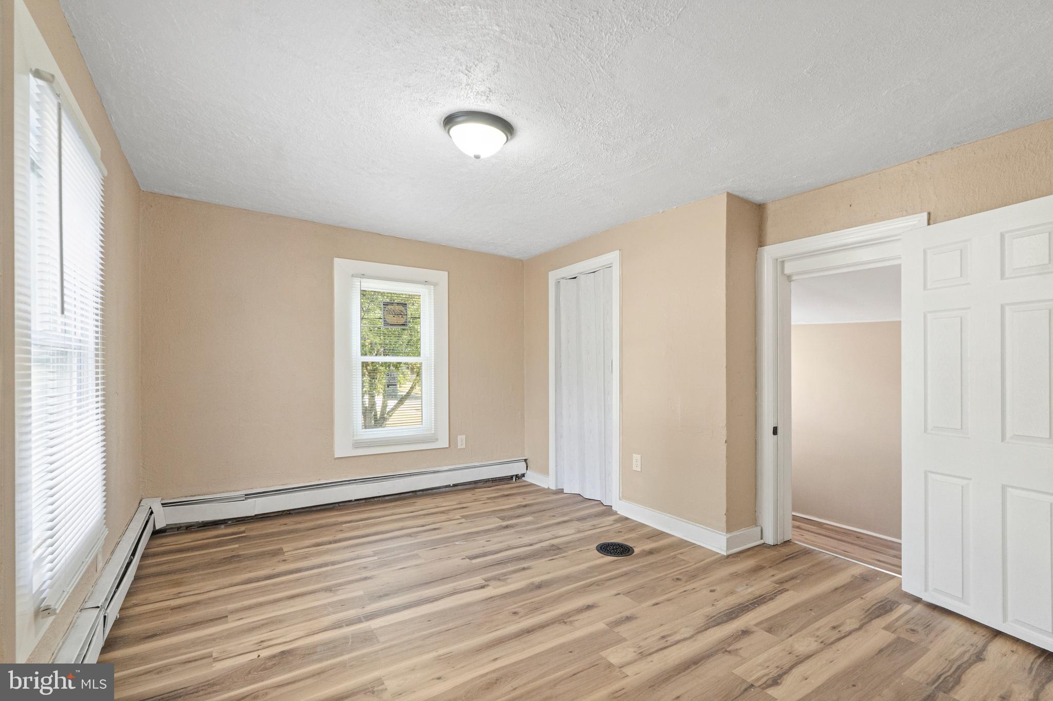 50 Pine Street Beverly, NJ 08010 - Photo 10 of 18 an empty room with wooden floor and windows