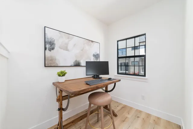 a table and chair in a room with a window