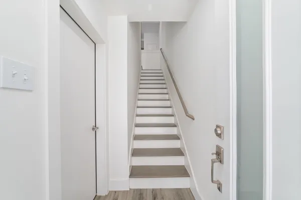 a view of entryway with wooden floor and stairs