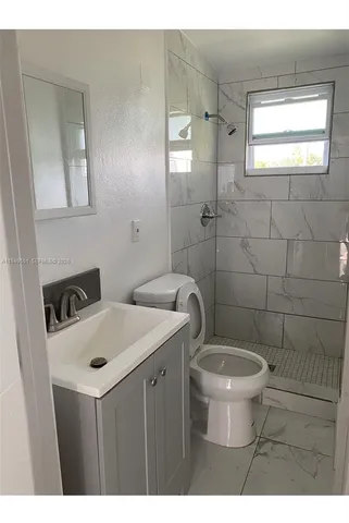 a bathroom with a sink toilet and mirror
