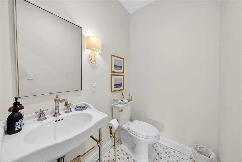 738 Smith Neck Road Dartmouth, MA 02748 - Photo 19 of 42 a bathroom with a sink toilet and mirror