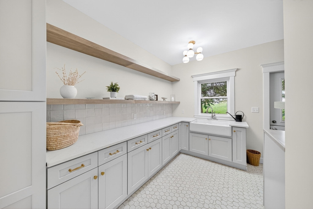 738 Smith Neck Road Dartmouth, MA 02748 - Photo 20 of 42 a spacious en suite bathroom with a granite countertop sink and a bathtub