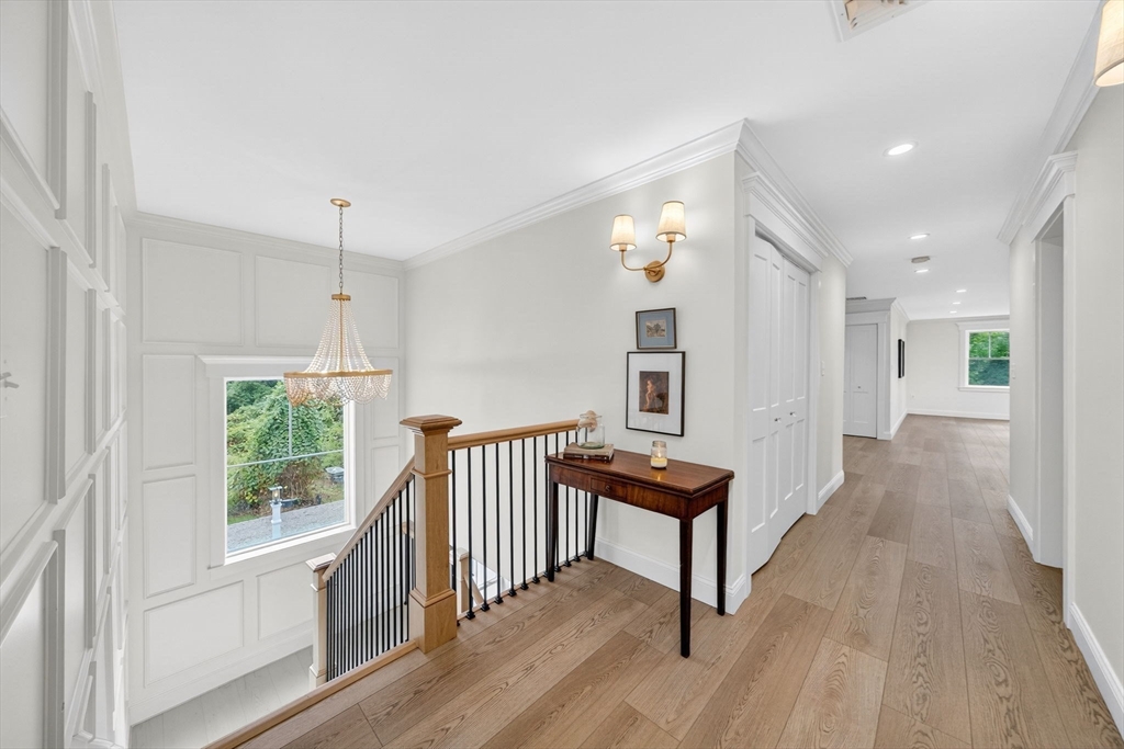738 Smith Neck Road Dartmouth, MA 02748 - Photo 22 of 42 a view of a hallway with wooden floor and furniture