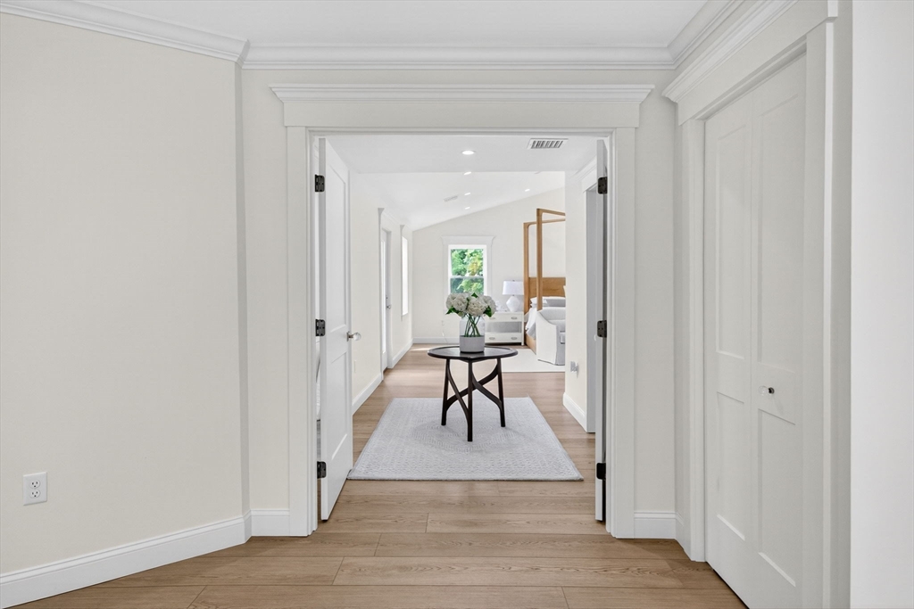 738 Smith Neck Road Dartmouth, MA 02748 - Photo 23 of 42 a view of a hallway with wooden floor and a living room