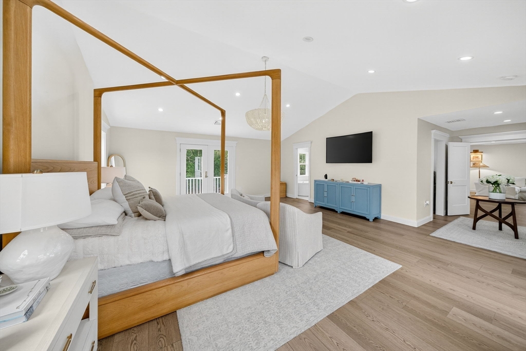 738 Smith Neck Road Dartmouth, MA 02748 - Photo 25 of 42 a spacious bedroom with a bed and a table in it