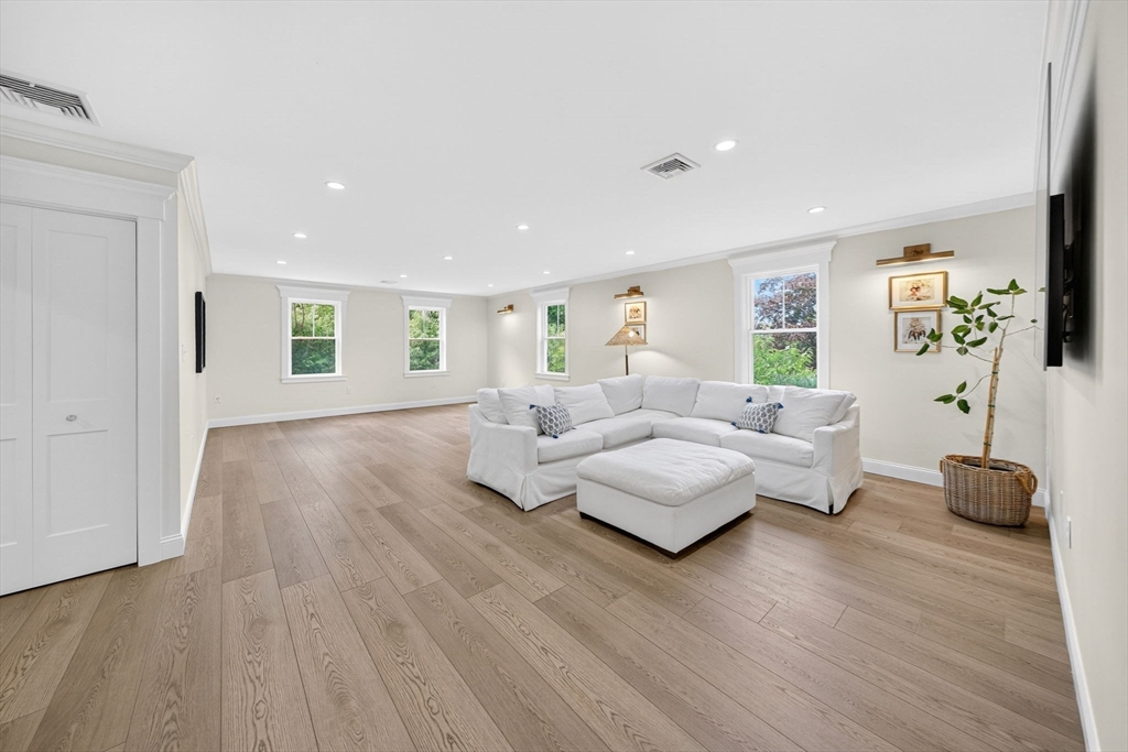 738 Smith Neck Road Dartmouth, MA 02748 - Photo 30 of 42 a living room with furniture and a wooden floor
