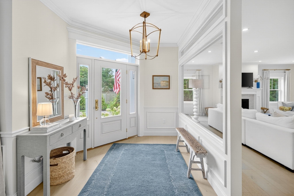 738 Smith Neck Road Dartmouth, MA 02748 - Photo 3 of 42 a view of a hallway with wooden floor and windows