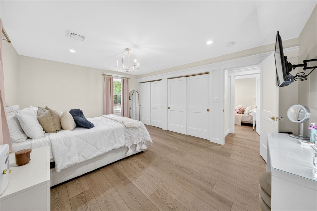 738 Smith Neck Road Dartmouth, MA 02748 - Photo 32 of 42 a spacious bedroom with a bed and a couch